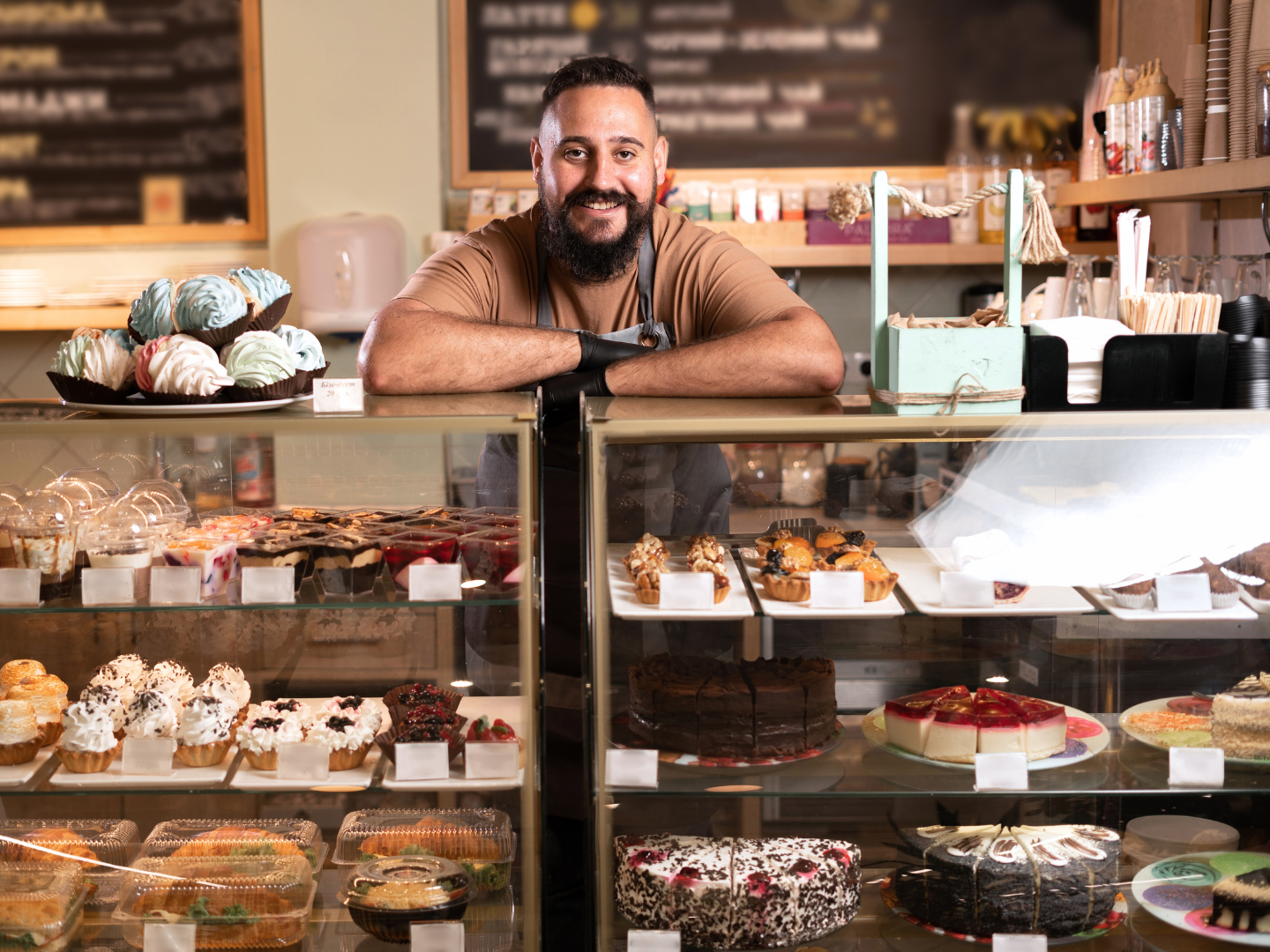 the owner of a bakery franchise stands at the counter of his shop recently funded with an sba 7(a) loan for 2025