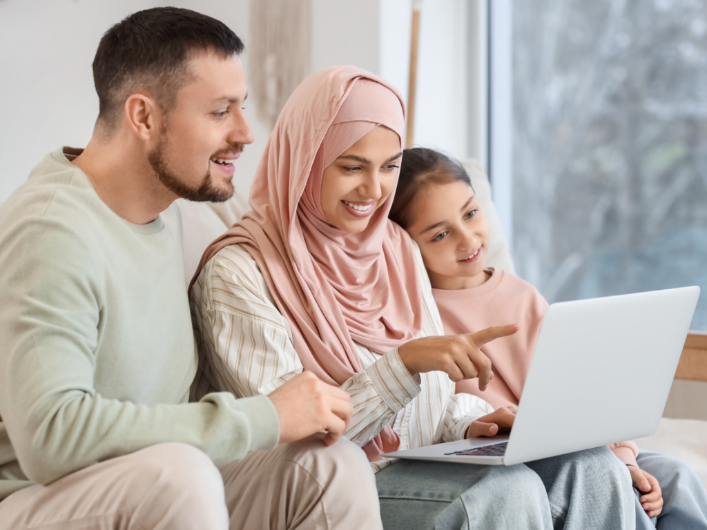 a father with medium skin and dark hair and a mother with medium skin and a pink  hijab sit with there daughter discussing strategies for using CDs for long term savings